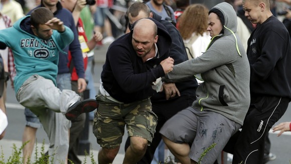 Fans clash prior to the Group A match between Poland and Russia in Warsaw, Poland on Tuesday.
