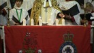 Reverend Canon Hilary Barber lights the last of the six candles to remember the six killed in Afghanistan