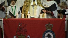 Reverend Canon Hilary Barber lights the last of the six candles to remember the six killed in Afghanistan 