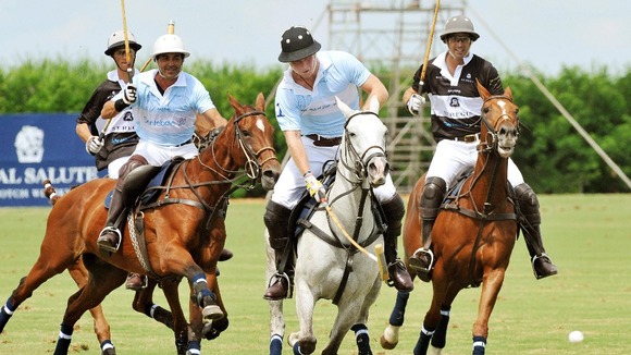 Prince Harry (centre) in action during a the polo match