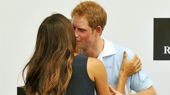 Prince Harry being kissed by Brazilian supermodel Fernanda Mutta after the Polo match where he captained Sentebale against St Regis