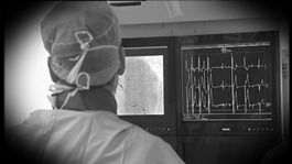 surgeon looking at heart monitor