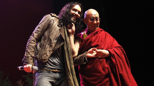 Russell Brand and the Dalai Lama on stage at The Manchester Evening News Arena.