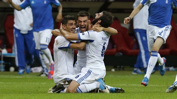Greek players celebrate on the pitch in Warsaw