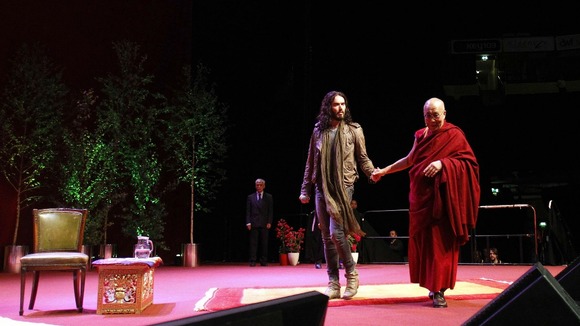Russell Brand and the Dalai Lama on stage at The Manchester Evening News Arena.