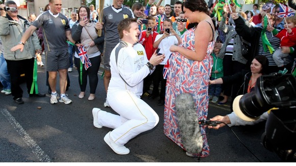 Torchbearer David State pops the question during the Olympic relay.
