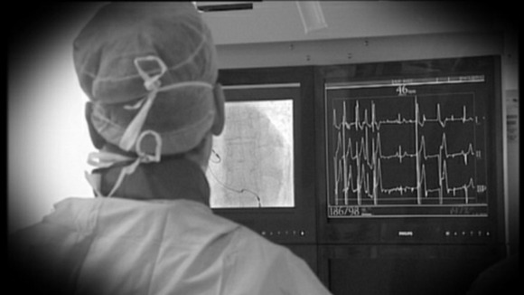 surgeon looking at heart monitor