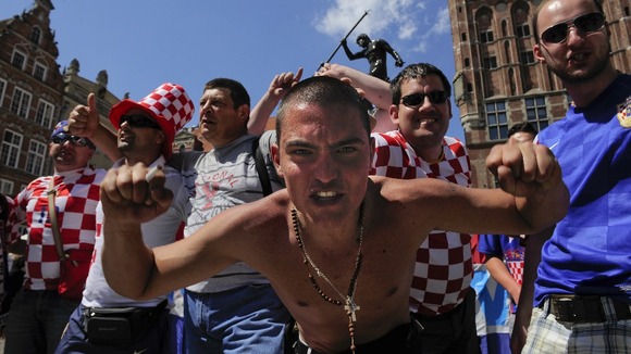 A Croatia fan looks fiercely into the camera.