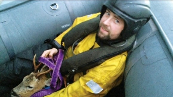 Petty Officer Andrew Rodgers and the rescued deer