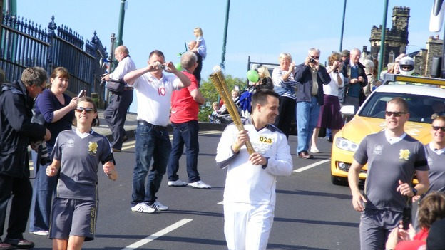 Robert Swift carries the torch along Saltburn's final leg of the relay