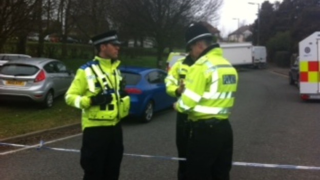 Police officers maintaining cordon in Perry Hill Road