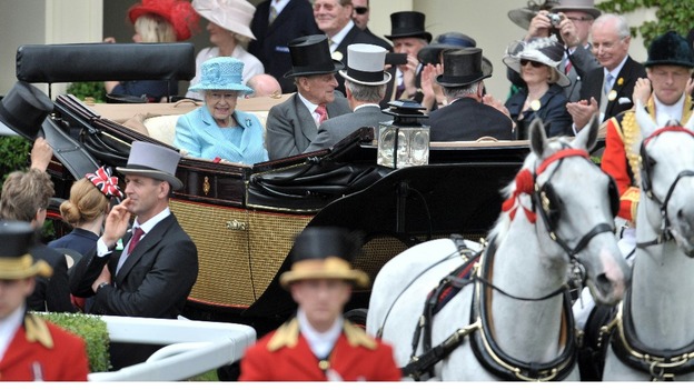 The Queen and Duke of Edinburgh arrive in a horse-drawn carriage at Royal Ascot.