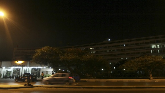 Police officers and military police stand guard outside Maadi military hospital,