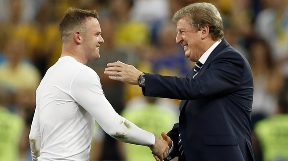 Roy Hodgson celebrates with goalscorer Wayne Rooney after England won through.