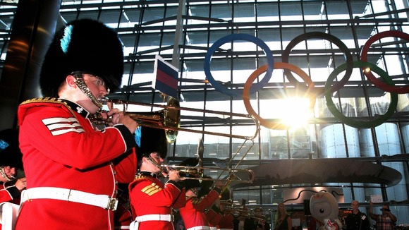 The Band of the Irish Guards perform as the giant Olympic Rings are unveiled at Terminal 5 of Heathrow Airport.