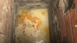 Grease clinging to pipes in a sewExample of grease pulled from a blocked drainer
