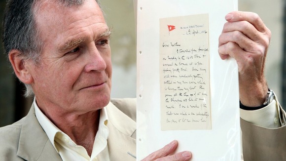 Dr John Martin the great-nephew of Dr John Simpson holds the letter sent from the Titanic