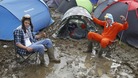 Blaise Franklin (left) and Nathan Mursall wallow in the mud at the campsite at the Isle of Wight Festival.