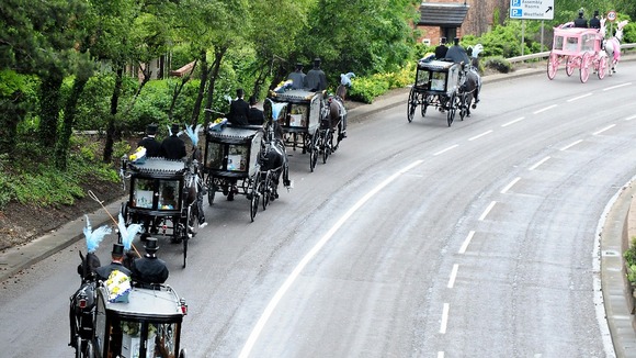 The horse-drawn carriages carrying the coffins, the pink carriage carrying Jade's.