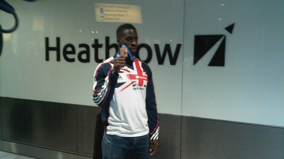 Dwain Chambers displays his bronze medal in Heathrow this evening