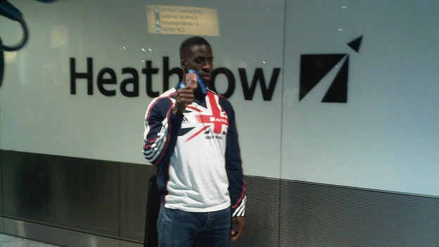 Dwain Chambers displays his bronze medal in Heathrow this evening