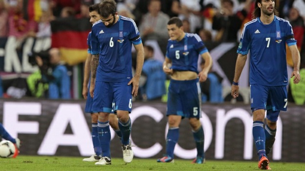 Greek players look despondent after conceding a goal.