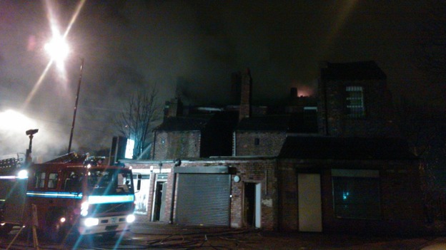 Fire engine next to row of shops