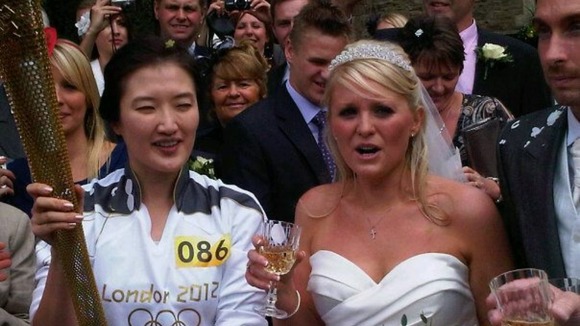 Bride Catherine Heys with the torch bearer in Rawtenstall