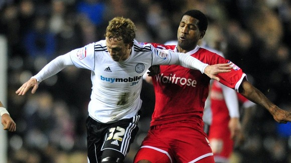 Paul Green faces up against a Reading player at Pride Park