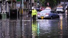 Floodwaters surround local shops in centre of Hebden Bridge, West Yorkshire.