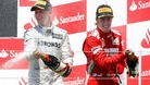 Ferrari Formula One driver Fernando Alonso, from Spain, right, celebrates his victory next to Mercedes driver Michael Schumacher, left.