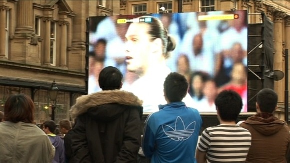 Fans watch football on big screen