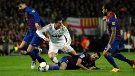 Spain midfielder Sergio Busquets tackles Cristiano Ronaldo in the Copa del Rey.