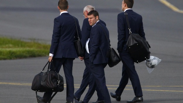 The England players land in the UK after defeat against Italy.