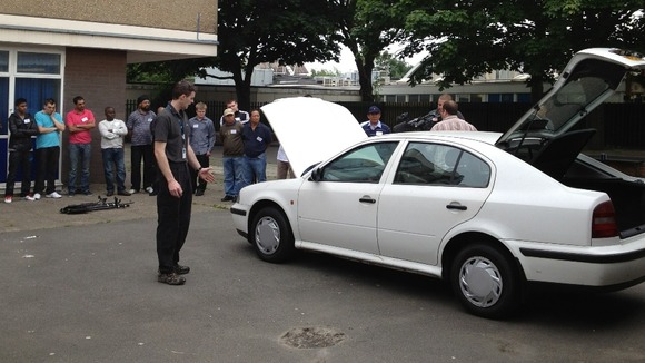 Recruits watch a demo of searching a car