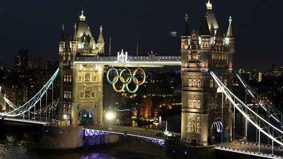 The Olympic rings are lit below Tower Bridge to mark the one month countdown to the Olympic Games