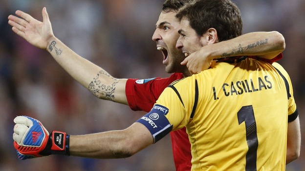 Spain midfielder Cesc Fabregas celebrates with Iker Casillas.