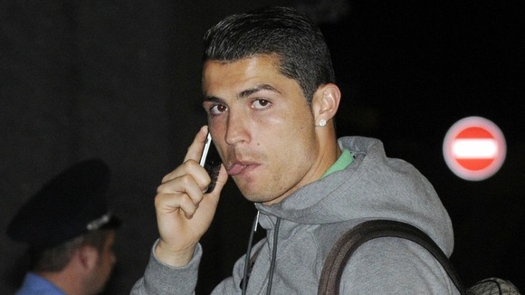 Portugal's Cristiano Ronaldo talks on his phone at the airport in Donetsk, Ukraine.