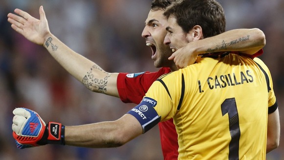 Spain's Cesc Fabregas celebrates with his teammate Iker Casillas after scoring the decisive penalty.