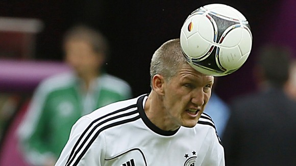 Germany's Bastian Schweinsteiger heads the ball during training in Warsaw.