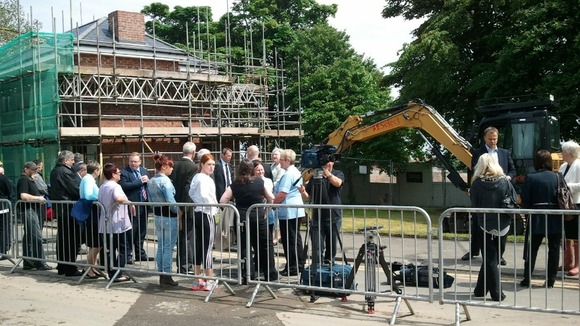 Spectators look on as the official turf cutting ceremony.