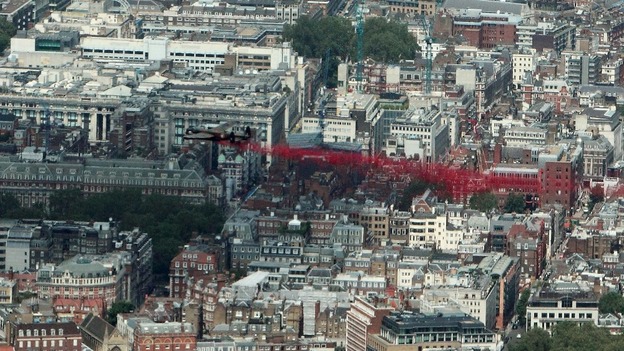 A Lancaster bomber drops poppies over Green Park in central London.