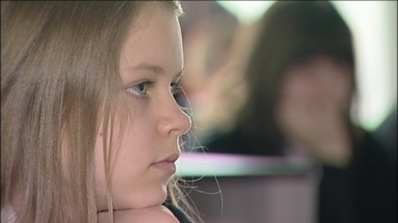 Pupil listens to trainee teacher