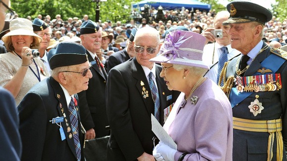 Queen Elizabeth II and the Duke of Edinburgh talk to Ed Carter-Edwards a former member of Bomber Command from Canada