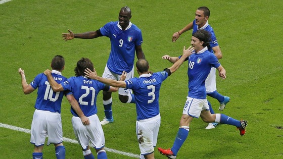 Italy's Mario Balotelli, top left, is celebrated by teammates after scoring the opening goal during the Euro 2012  Semi Final 