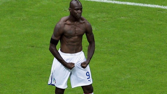 Italy's Mario Balotelli celebrates scoring his side's second goal by taking off his shirt 