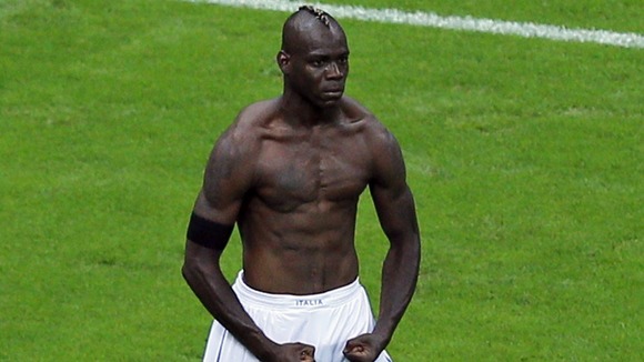 Italy striker Mario Balotelli celebrates his second goal.