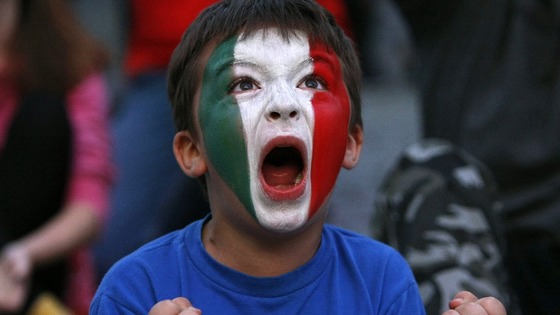 A young Italy soccer fan celebrates during the Euro 2012 semi-final match between Germany and Italy