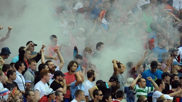 Russia fans set off a flare.