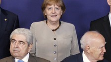 Cyprus' President Demetris Christofias and Greece's President Karolos Papoulias and Angela Merkel